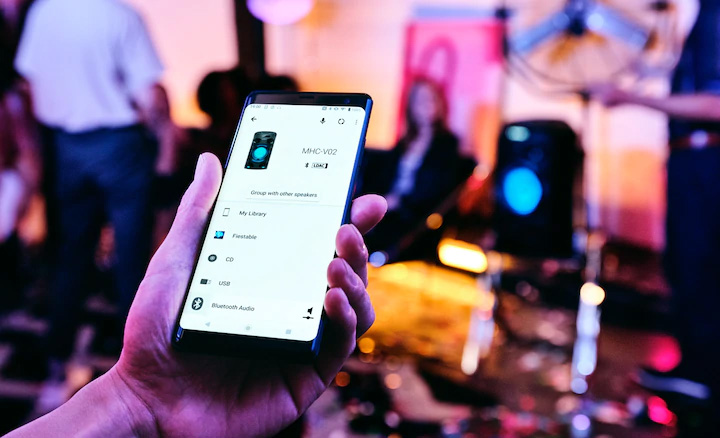 Khách dự tiệc dùng ứng dụng Sony | Music Center trên điện thoại thông minh